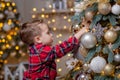 Little boy decorating Christmas tree with toy balls Royalty Free Stock Photo