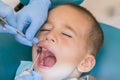 A little boy at a dentist's reception in a dental clinic. Children's dentistry, Pediatric Dentistry. A female stomatologist is