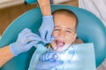 A little boy at a dentist& x27;s reception in a dental clinic. Children& x27;s dentistry, Pediatric Dentistry. A female