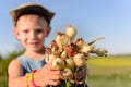 Little boy displaying a bunch of fresh onions Royalty Free Stock Photo