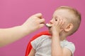 Little boy does not want to eat Mashed potatoes. Child eats breakfast at home, while watching cartoon on tablet Royalty Free Stock Photo