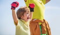 Little boy doing boxings exercise with grandfather. Father is training his son boxing. Little boy sportsman at boxing