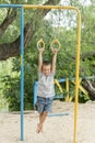 A little boy is doing phisical exercises on a Sportsground Royalty Free Stock Photo