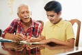 Little Boy Doing School Homework With Old Man At Home Royalty Free Stock Photo