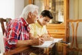 Little Boy Doing School Homework With Old Man At Home Royalty Free Stock Photo