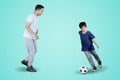 Little boy doing soccer exercises with his father Royalty Free Stock Photo