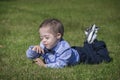 Little Boy with Down syndrome Lying on Grass