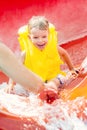 Little boy down with a water slide Royalty Free Stock Photo