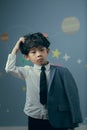 A little boy in a suit looks tiredly at the camera Royalty Free Stock Photo