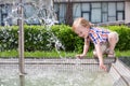 Little boy draw water from the fountain in the Royalty Free Stock Photo