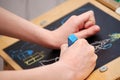 Little boy drawing Christmas scene on the chalkboard Royalty Free Stock Photo