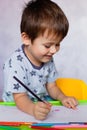 Little boy drawing with color pencils. Boy, drawing a picture for fathers day. Small boy draws at the table Royalty Free Stock Photo