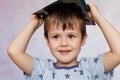 Little boy drawing with color pencils. Little boy is holding color pencils. Boy, drawing a picture for fathers day Royalty Free Stock Photo