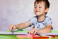 Little boy drawing with color pencils. Boy, drawing a picture for fathers day. Small boy draws at the table