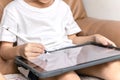 Little boy Drawing Digital Picture On Electronic Touch Tablet With Stylus Pen Royalty Free Stock Photo