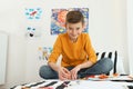 Little boy drawing picture on bed Royalty Free Stock Photo