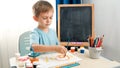 Little boy drawing picture in school classroom. Creative child doing art painting. Education at home during lockdown Royalty Free Stock Photo