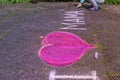 Little boy drawing of pink heart with chalk on sidewalk Royalty Free Stock Photo