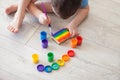 Little boy draws a rainbow on a sheet of paper in different colors