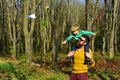 Little boy dream to fly high on fathers shoulder. Father and son launch paper plane in park. No matter what else happens