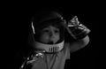 A little boy dreams of becoming an astronaut and flying into space. Cosmos childrens in spacesuit and helmet dreams Royalty Free Stock Photo