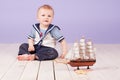 A little boy dressed as a sailor captain of ship