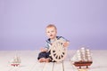 A little boy dressed as a sailor captain of ship