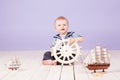 A little boy dressed as a sailor captain of ship