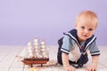 A little boy dressed as a sailor captain of ship