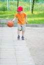 Little boy dribbling basketball