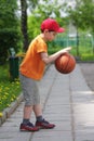 Little boy dribbling basketball sideview Royalty Free Stock Photo