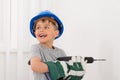 Little Boy Drilling Wall Royalty Free Stock Photo