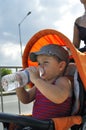 Little boy drink water sits in the stroller Royalty Free Stock Photo