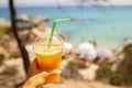 Little boy, drinking cocktail, orange juice on the beack in hammock, enjoying summer Chalkidiki, Greece