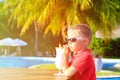 Little boy drinking cocktail on tropical beach Royalty Free Stock Photo