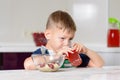 Little boy drinking fruit juice in a kitchen Royalty Free Stock Photo