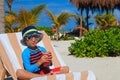 Little boy drinking juice on tropical beach Royalty Free Stock Photo