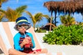 Little boy drinking juice on tropical beach Royalty Free Stock Photo