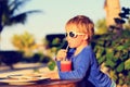 Little boy drinking juice on tropical beach Royalty Free Stock Photo