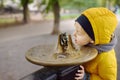 Little boy drinking water from city fountain during walking in Central Park, Manhattan, New York, USA Royalty Free Stock Photo