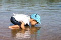 Little boy drinking water from the river Royalty Free Stock Photo