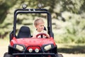 Little boy drive a mini electric car in park Royalty Free Stock Photo
