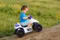 Little boy driving off road toy quad Royalty Free Stock Photo