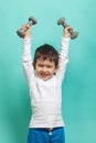 Little boy with dumbbells. Healthy lifestyle. Sports and activities for children.