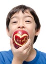 Little boy eating apple , love word on skin focus on apple isolate Royalty Free Stock Photo