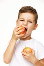 Little boy is eating apple studio shot Royalty Free Stock Photo