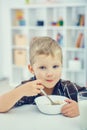 Little boy eating breakfast. Royalty Free Stock Photo
