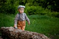 Little boy is eating cake, on background red car, balloons in the park. Birthday of the child Royalty Free Stock Photo