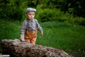 Little boy is eating cake, on background red car, balloons in the park. Birthday of the child Royalty Free Stock Photo