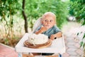 Little boy eating cake with his hands on a highchair Royalty Free Stock Photo